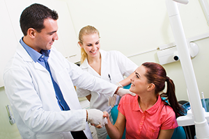 woman in dental chair meeting dentist for cosmetic dentistry Upland, CA